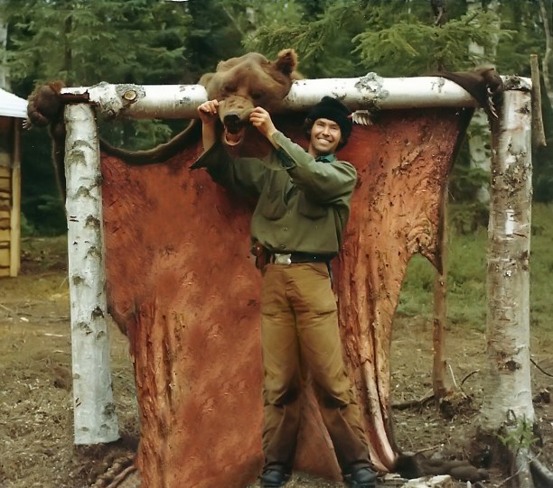 Sam's pretty happy that he brought this bear down. It had charged him and his friend up on the mountain.