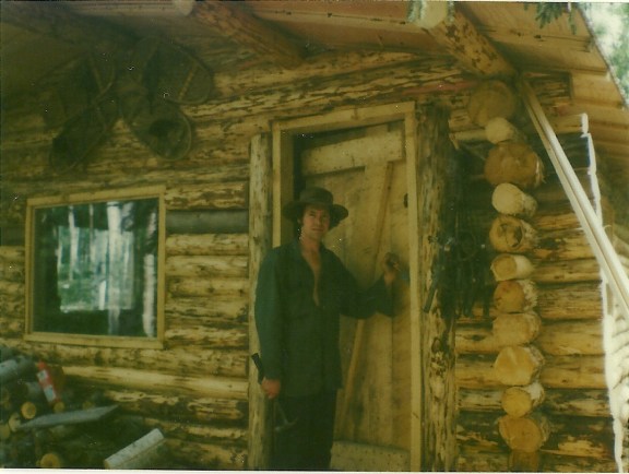 Sam is almost finished hanging the door! A good solid door! Let the cold winds blow, we'll be snug and warm in our little cabin home!